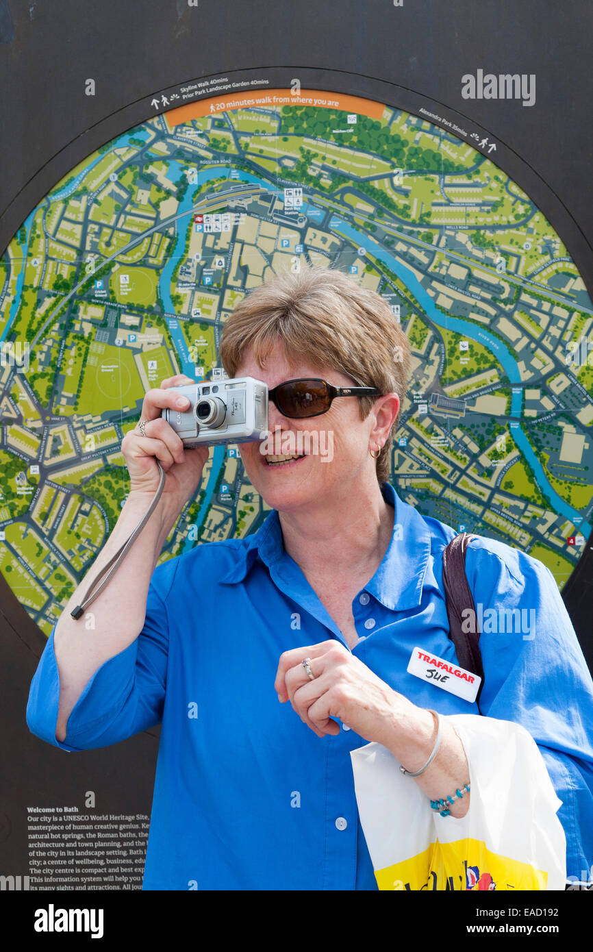 Tourist sightseeing – and taking a photograph – in and around Bath, Somerset UK. Stock Photo