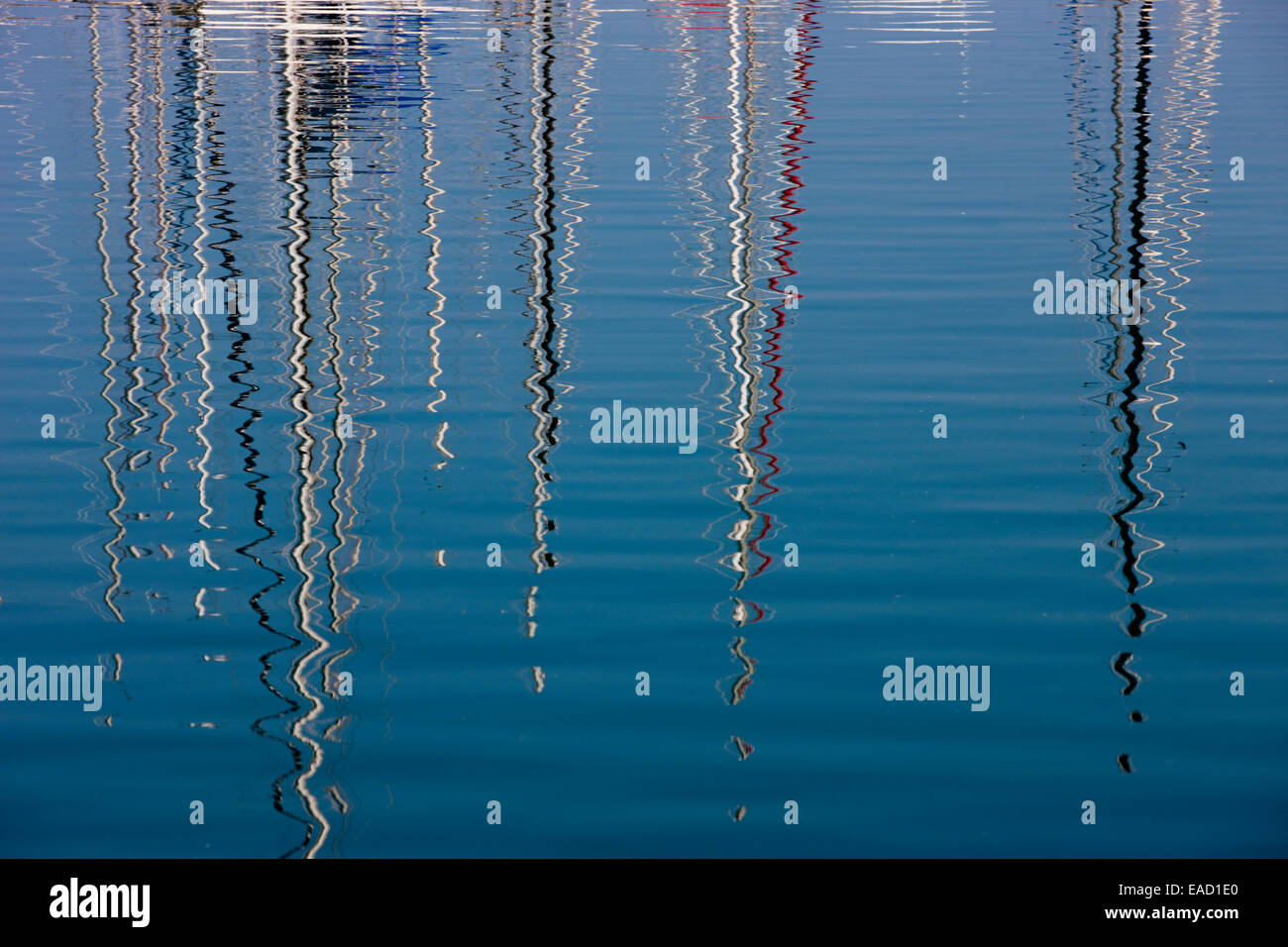 Boat masts reflecting in the sea, marina in Punta Ala, Tuscany, Italy Stock Photo