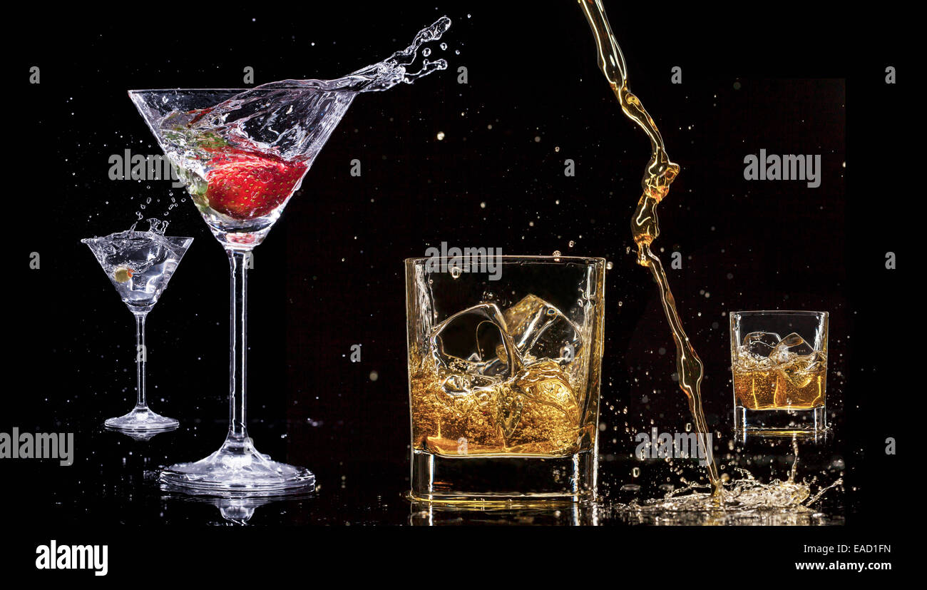 Alcohol drinks with splashes, isolated on black background Stock Photo