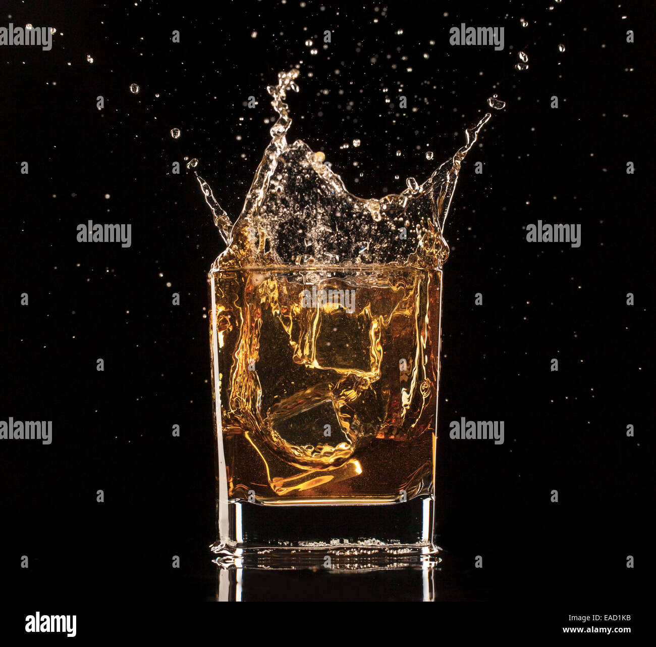 Isolated shot of whiskey with splash on black background Stock Photo