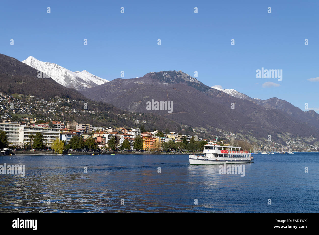 Excursion boat on Lake Maggiore with the city of Locarno, Ticino, Switzerland Stock Photo