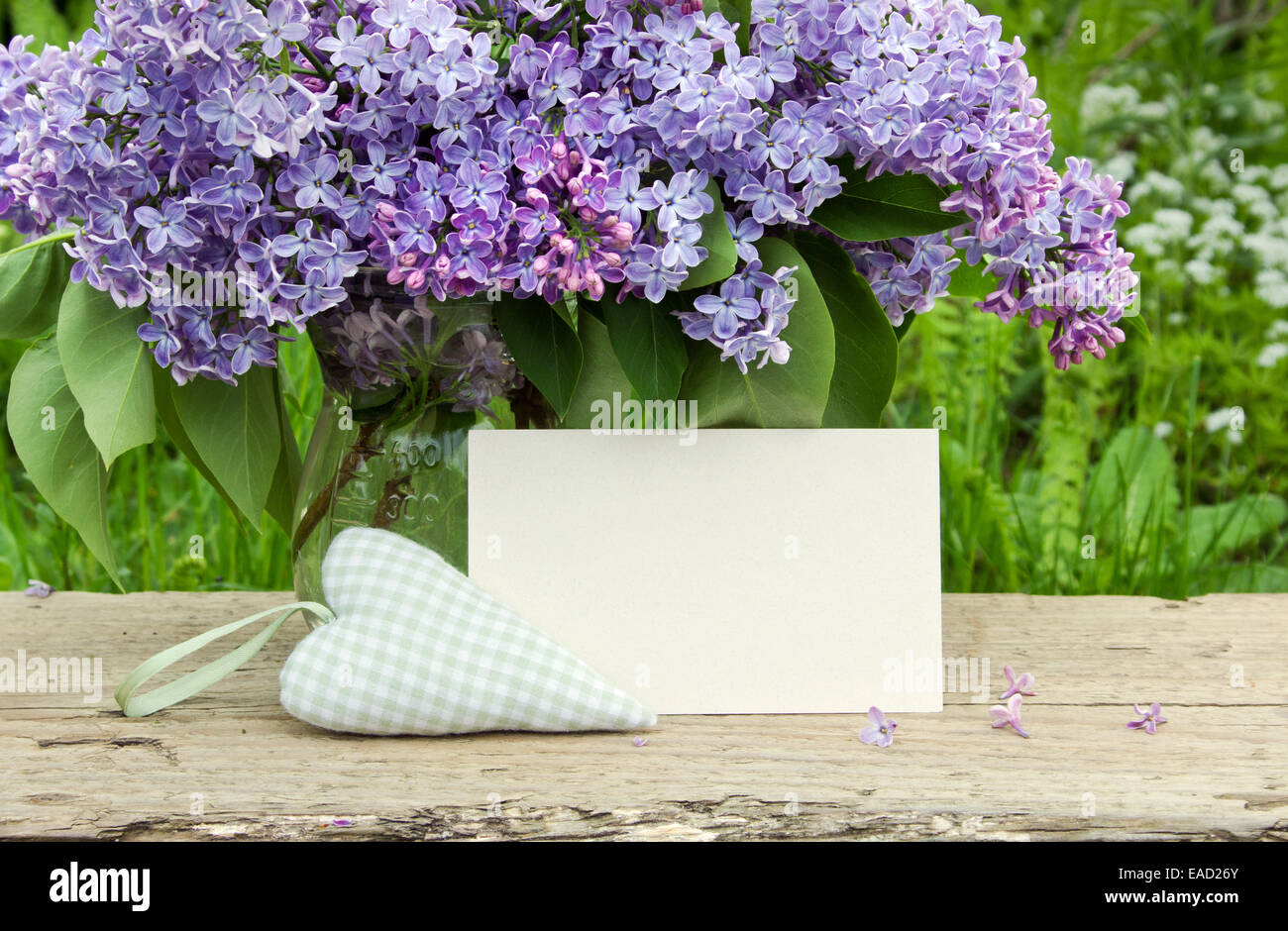Bouquet of lilac with white card and heart Stock Photo