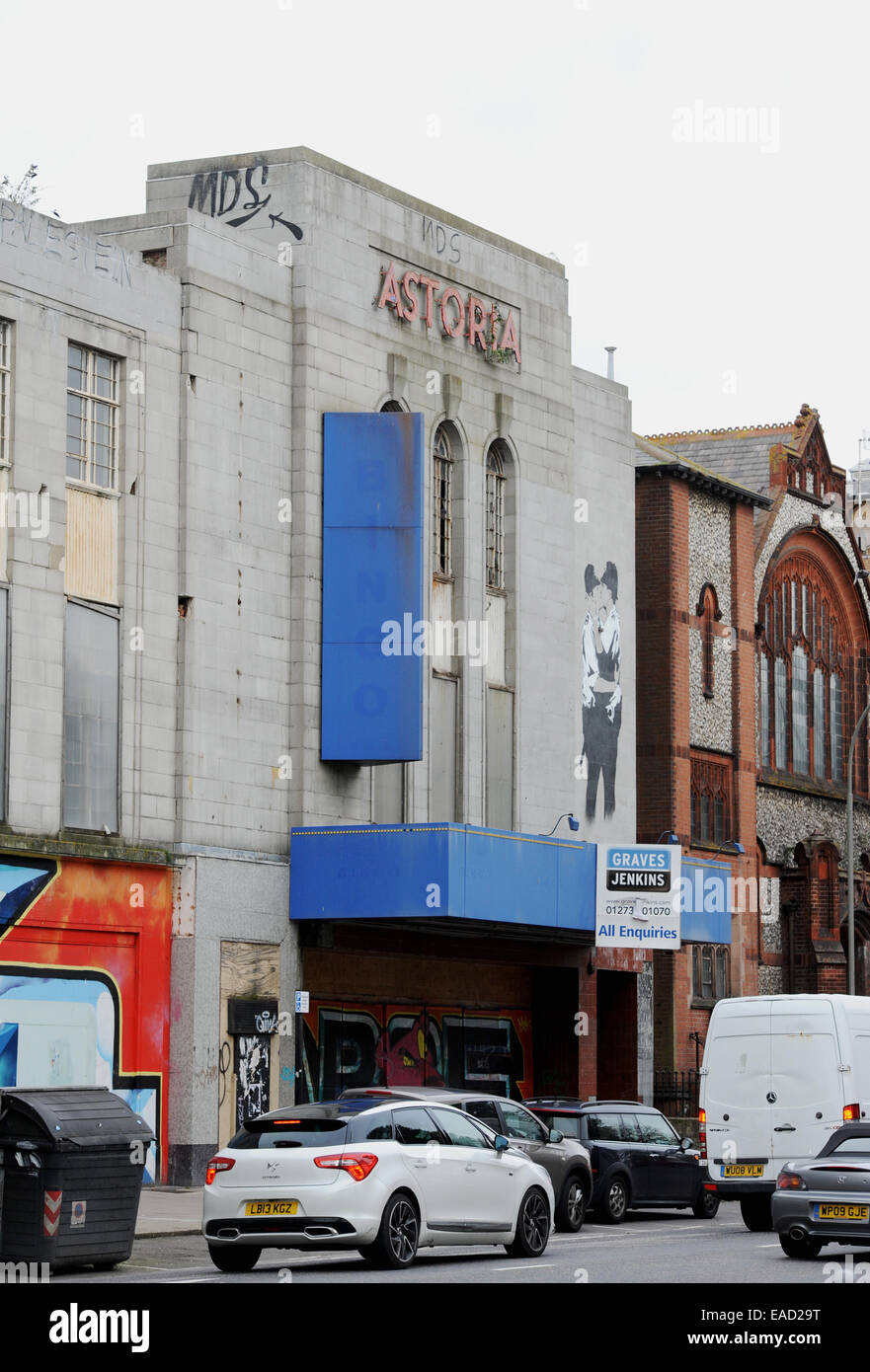 The derelict closed down Astoria theatre in Brighton which has a large copy of the famous Banksy mural The Kissing Coppers Stock Photo
