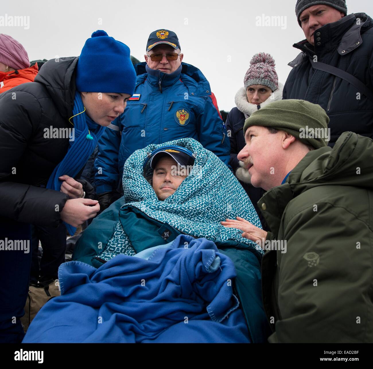 ISS Expedition 41 astronaut Reid Wiseman of NASA sits outside the Soyuz Capsule just minutes after landing in a remote area November 10, 2014 near Arkalyk, Kazakhstan. Suraev, Wiseman and Gerst returned to Earth after more than five months onboard the International Space Station where they served as members of the Expedition 40 and 41 crews. Stock Photo