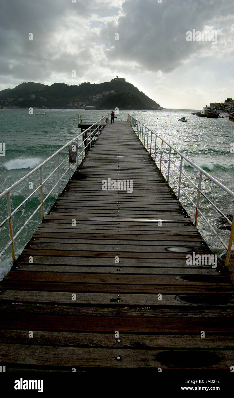 Footbridge of  Nautical Club in San Sebastian, Spain. Santa Clara Island and Igueldo Castle in background. Stock Photo