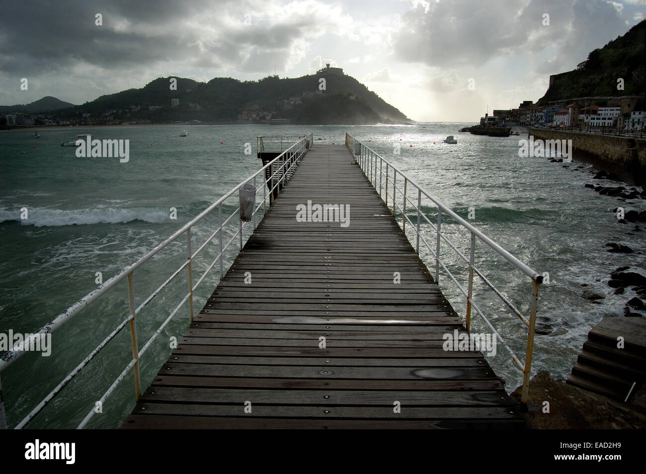 Footbridge of  Nautical Club in San Sebastian, Spain. Santa Clara Island and Igueldo Castle in background. Stock Photo