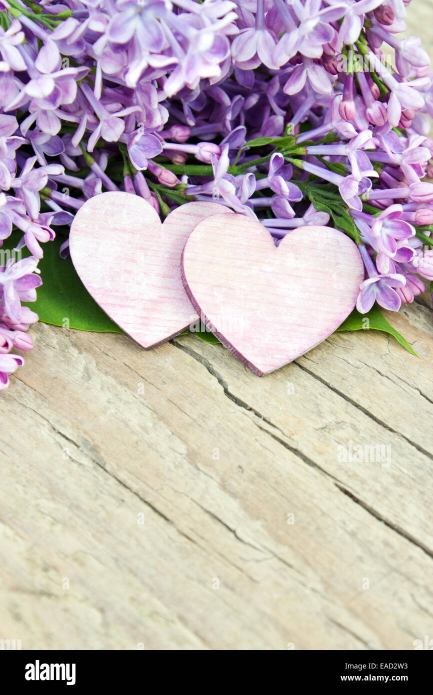 lilac with two hearts on wooden board Stock Photo