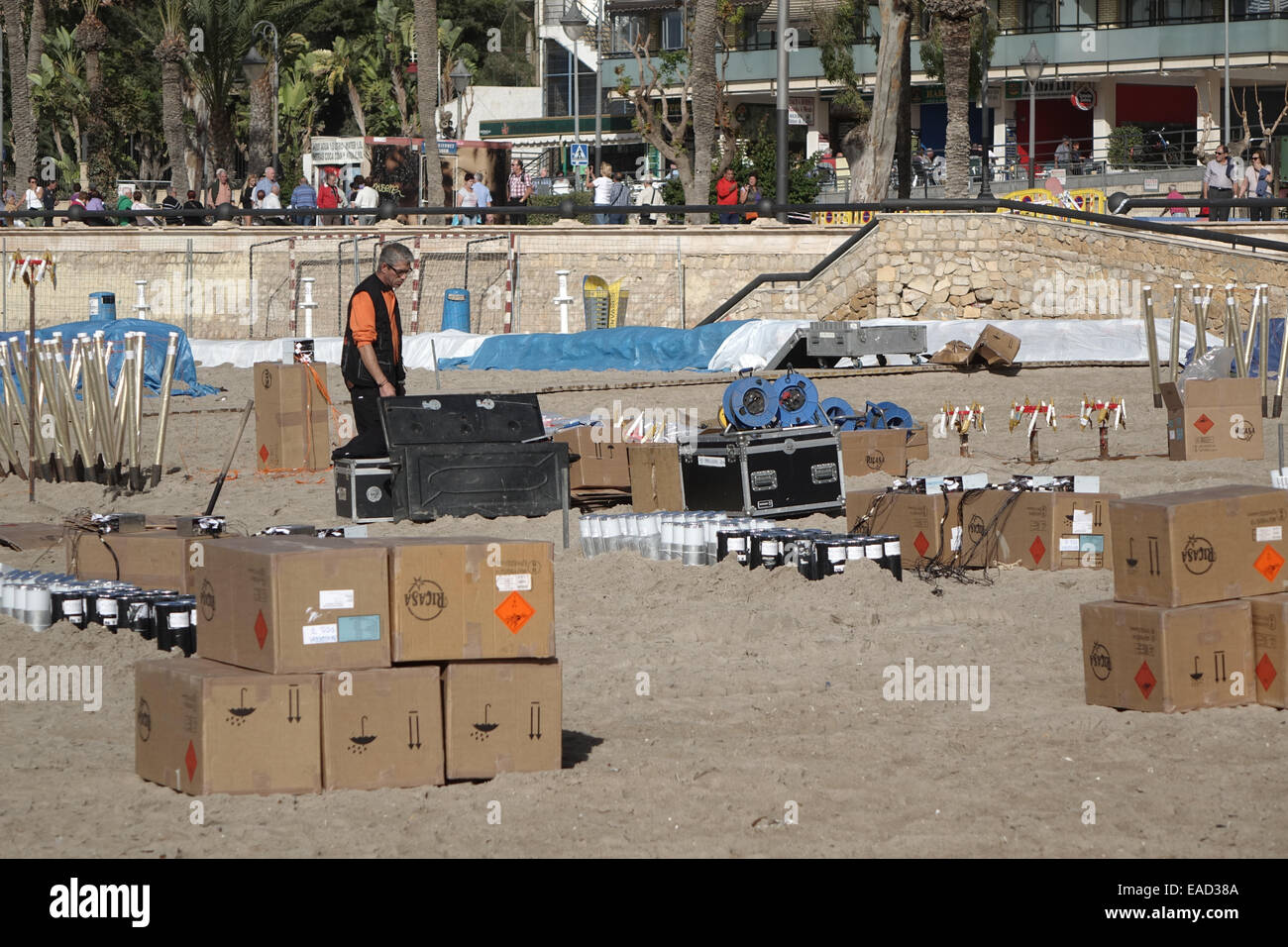 Benidorm, Spain. 12th November, 2014. The preparations for the final, gigantic fireworks spectacular of the Fiesta which happens tonight at 9pm are taking place in clear sunny weather on Poniente beach in Benidorm. Hundreds of explosive charges and mortar tubes which contain the larger fireworks are visible on the tourist beach which is fenced off for the popular event. Credit:  Mick Flynn/Alamy Live News Stock Photo