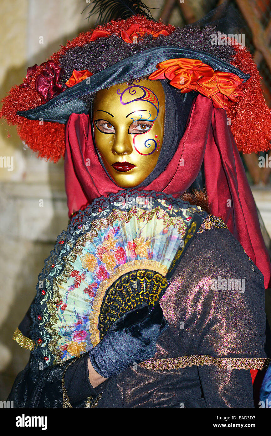 Woman with gold mask and costume, Carnival Venice Stock Photo