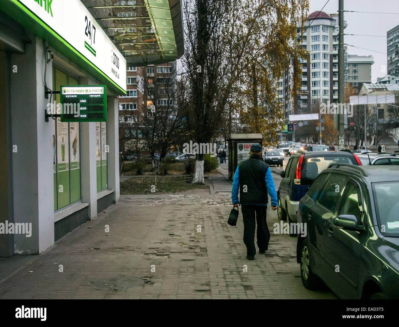 Kiev, Ukraine. 11th November, 2014. A man walks past PrivatBank focused on serving VIP customers. The display no indication exchange rate, as the bank buys foreign currency but does not sell. -- Ukraine continues to fall in the national currency. Prime Minister of Ukraine Arseniy Yatsenyuk hopes that the International Monetary Fund to help the National Bank in the exchange rate policy. About this Yatsenyuk said at the Cabinet meeting on November 12, 2014. Credit:  Igor Golovnov/Alamy Live News Stock Photo