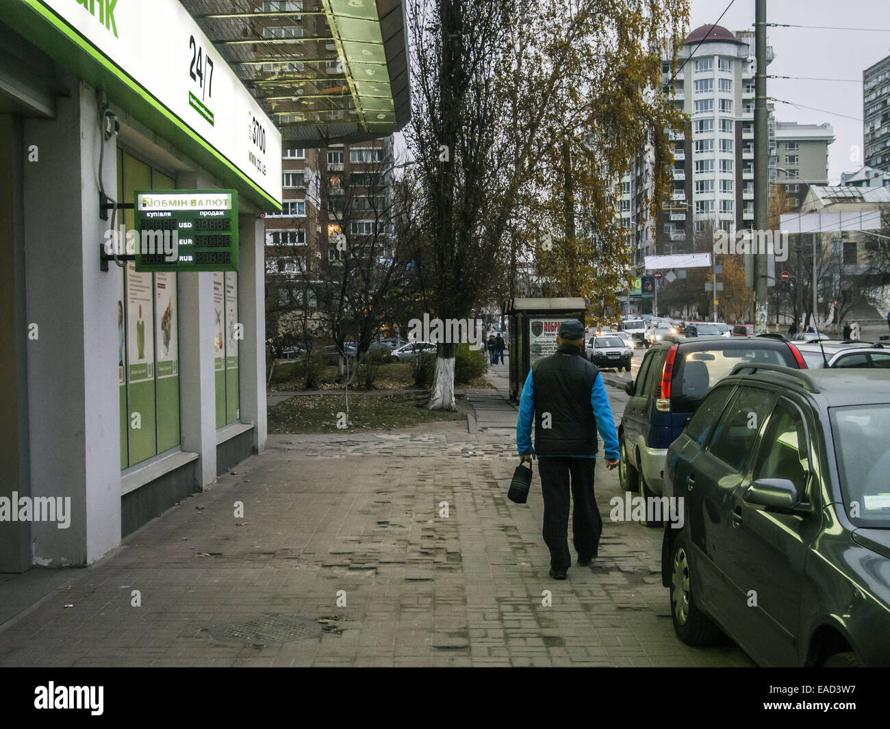 Nov. 11, 2014 - A man walks past PrivatBank focused on serving VIP customers. The display no indication exchange rate, as the bank buys foreign currency but does not sell. -- Ukraine continues to fall in the national currency. Prime Minister of Ukraine Arseniy Yatsenyuk hopes that the International Monetary Fund to help the National Bank in the exchange rate policy. About this Yatsenyuk said at the Cabinet meeting on November 12, 2014. The head of the National Bank of Valery Gontareva hopes to receive the combined third and fourth tranches, and the fifth tranche of the International Monetary F Stock Photo