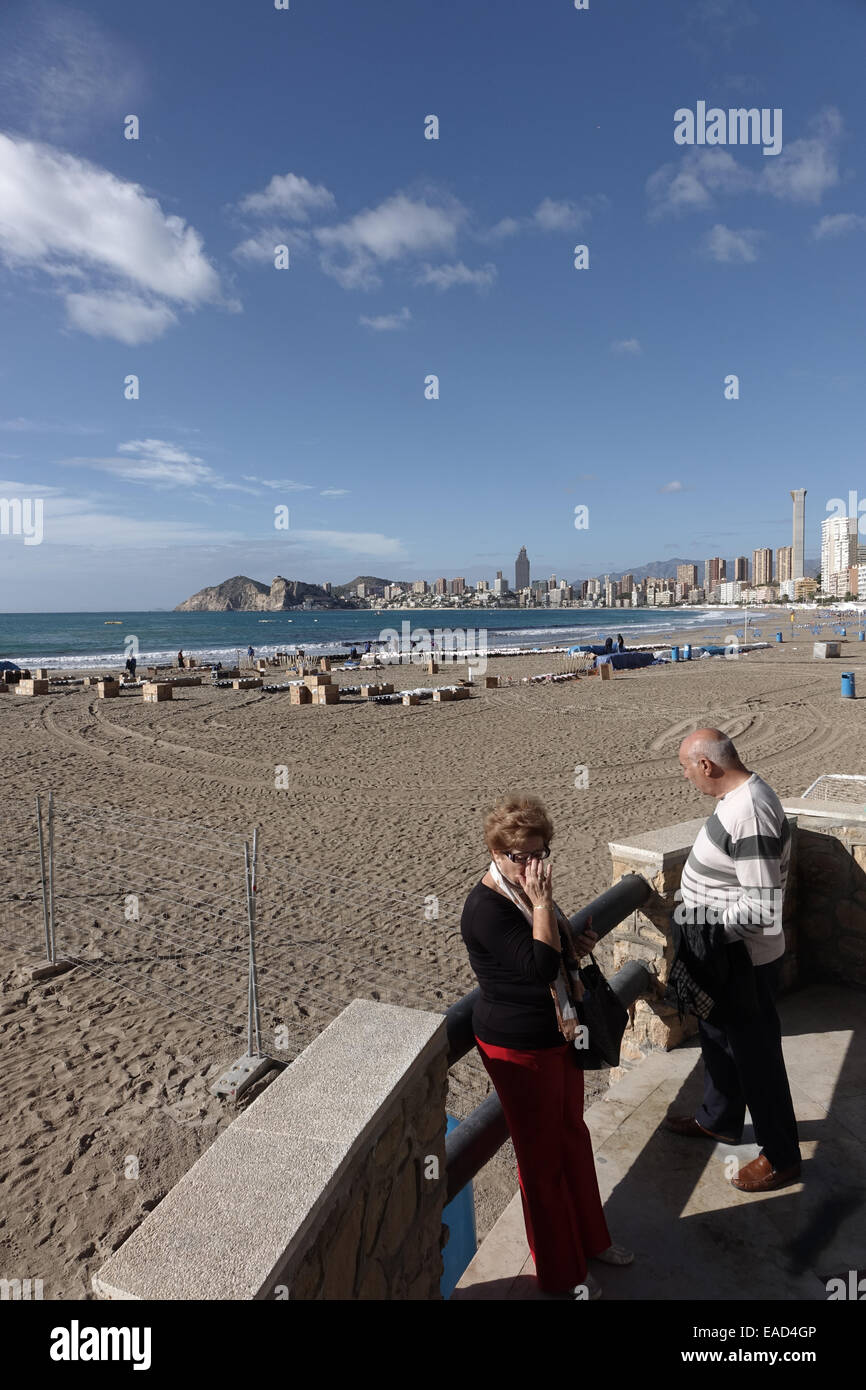 Benidorm, Spain. 12th November, 2014. The preparations for the final, gigantic fireworks spectacular of the Fiesta which happens tonight at 9pm are taking place in clear sunny weather on Poniente beach in Benidorm. Hundreds of explosive charges and mortar tubes which contain the larger fireworks are visible on the tourist beach which is fenced off for the popular event. Credit:  Mick Flynn/Alamy Live News Stock Photo