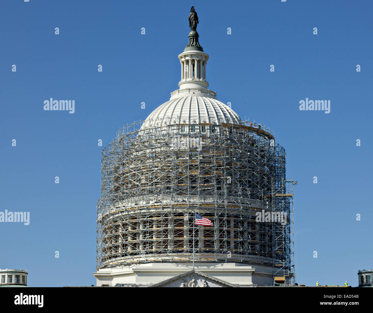 Workers create a scaffold encasing the US Capitol Dome November 12, 2014 in Washington, DC. The $60 million dollar project is to stop the deterioration of the cast iron dome and preserve it for the future. Stock Photo