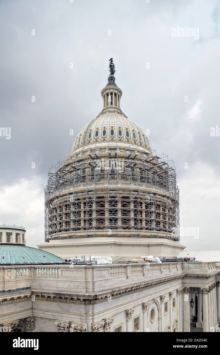 Workers create a scaffold encasing the US Capitol Dome November 10, 2014 in Washington, DC. The $60 million dollar project is to stop the deterioration of the cast iron dome and preserve it for the future. Stock Photo
