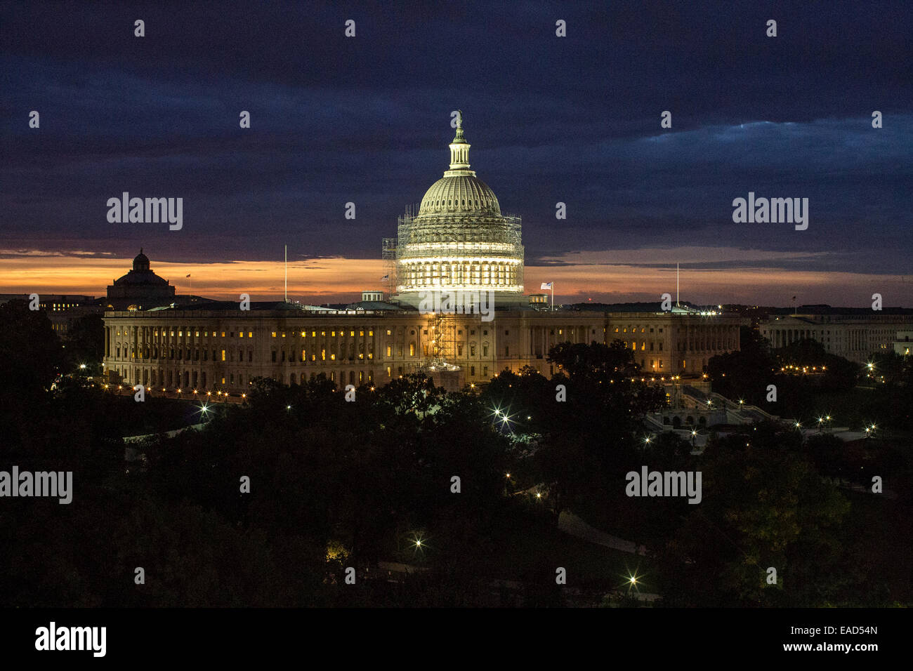 The US Capitol Dome surrounded by scaffolding illuminated on a stormy night November 10, 2014 in Washington, DC. The $60 million dollar project is to stop the deterioration of the cast iron dome and preserve it for the future. Stock Photo