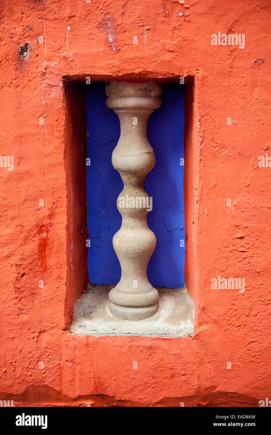 A stone pillar inset in a wall of the Lady's Lodge, Portmeirion, Gwynedd, Wales Stock Photo