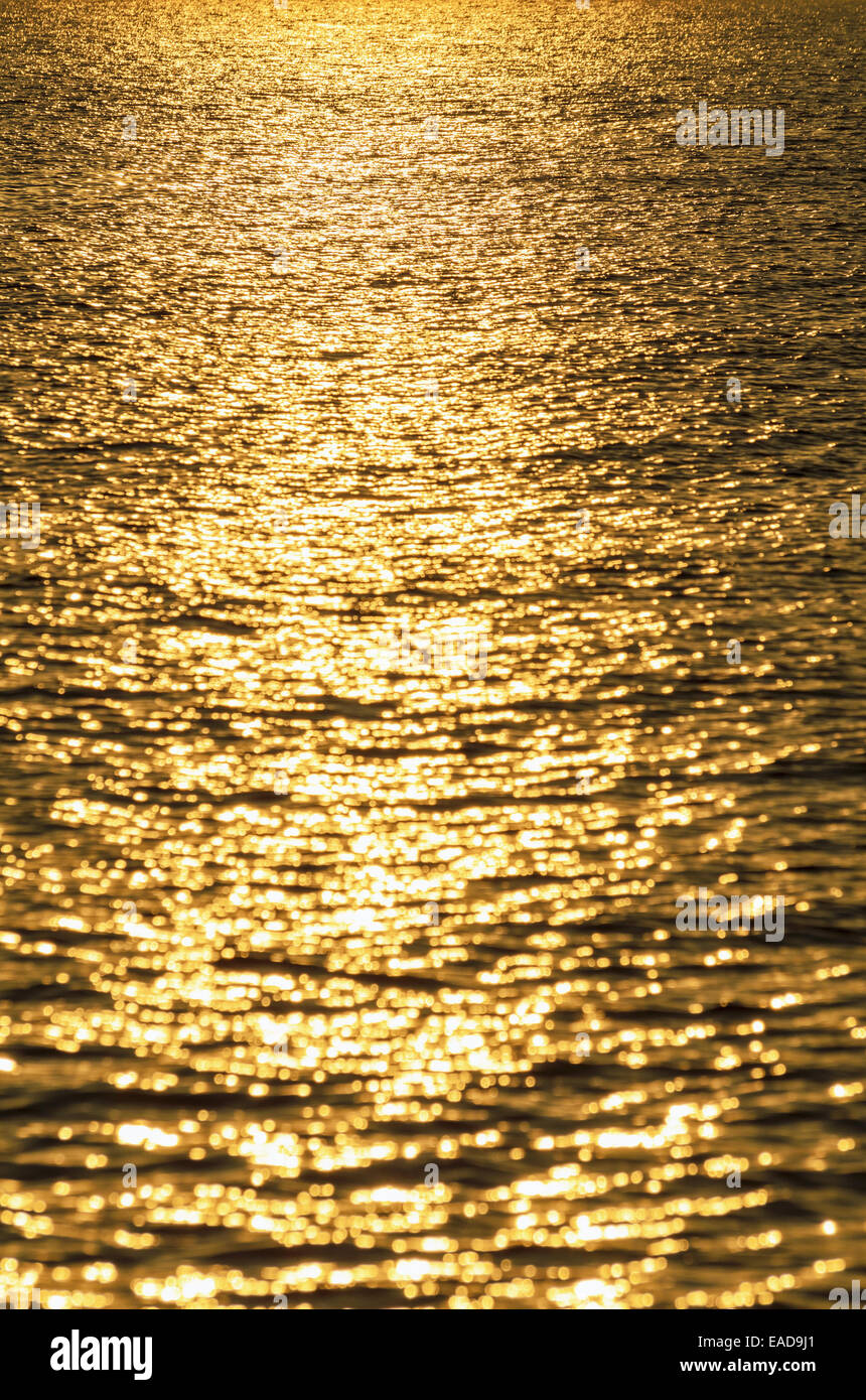 Background of water with golden sunrise reflections Stock Photo - Alamy