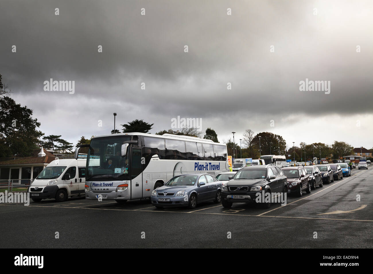 Cars and coaches waiting in lanes to load on a ferry Stock Photo