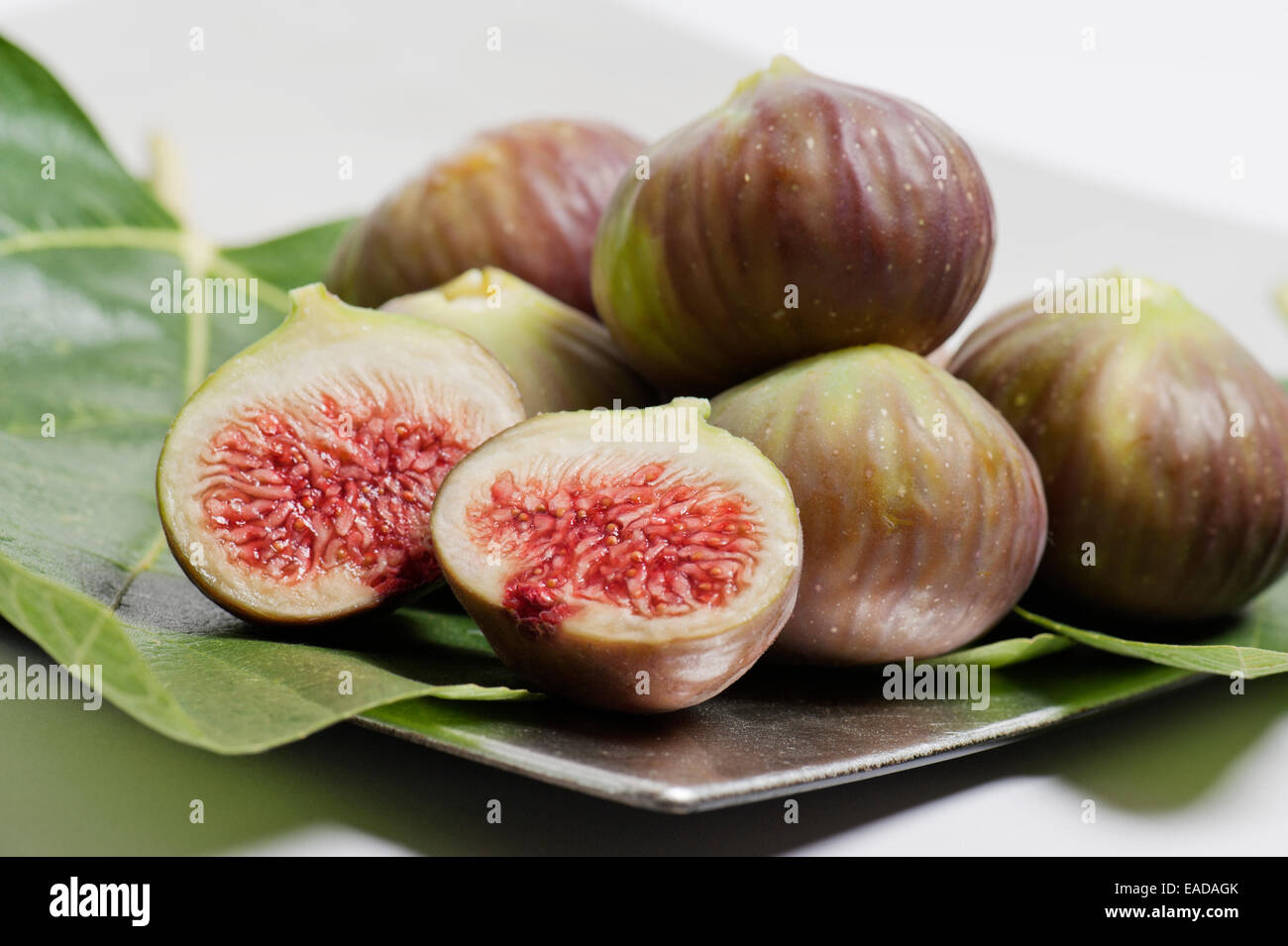 ripe figs on silver tray with foliage Stock Photo