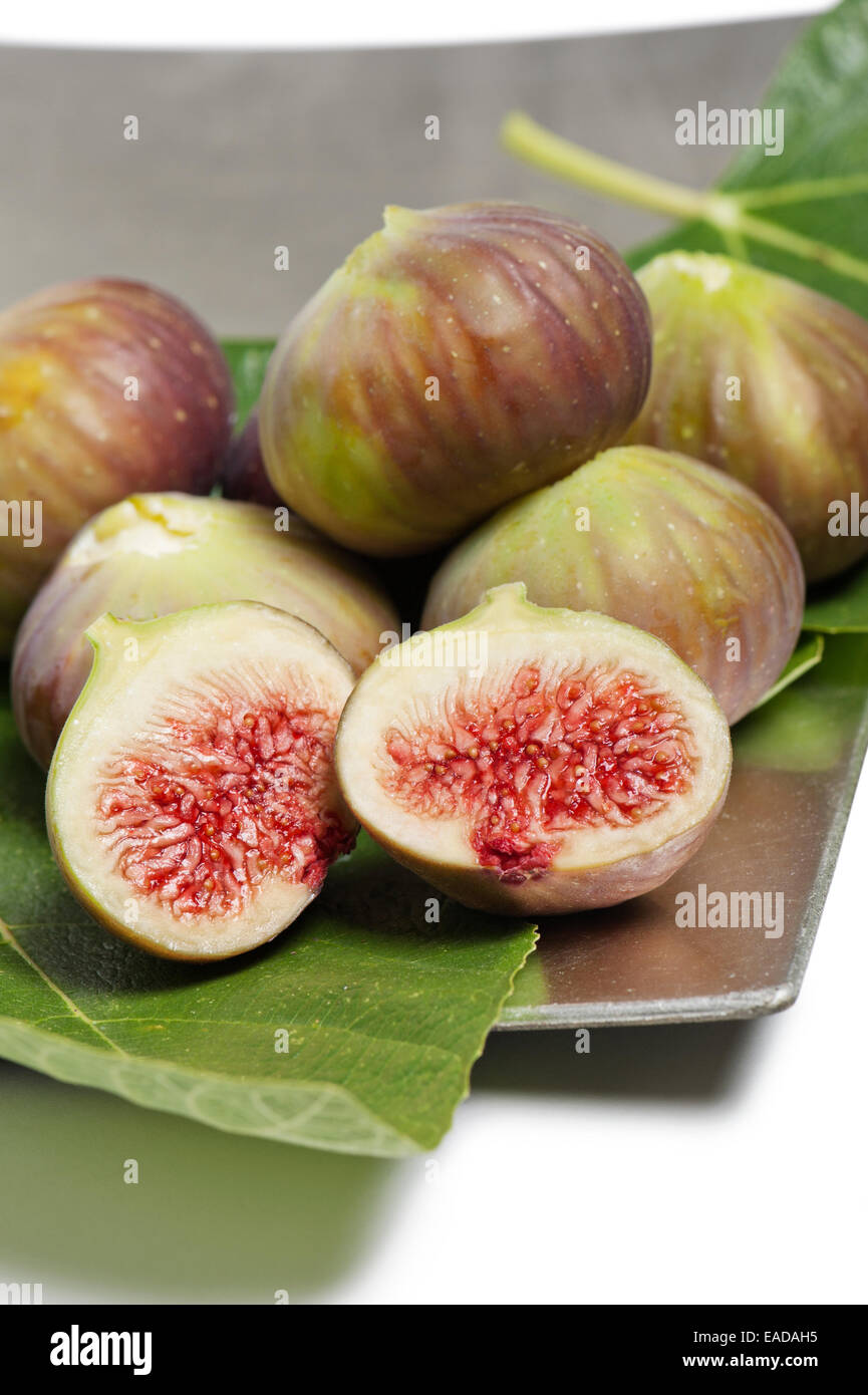 ripe figs on silver tray with foliage Stock Photo