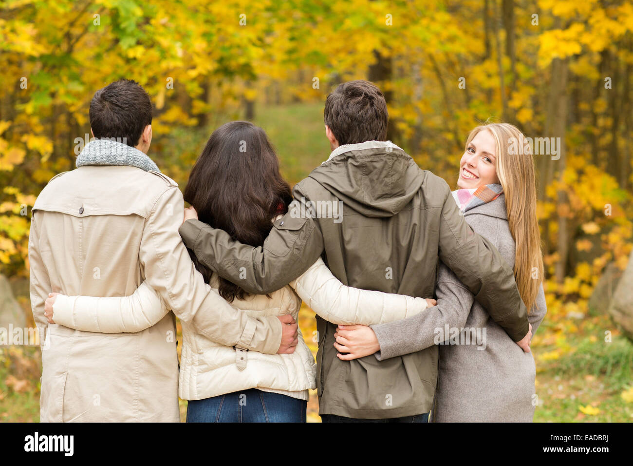 group of smiling men and women in autumn park Stock Photo - Alamy