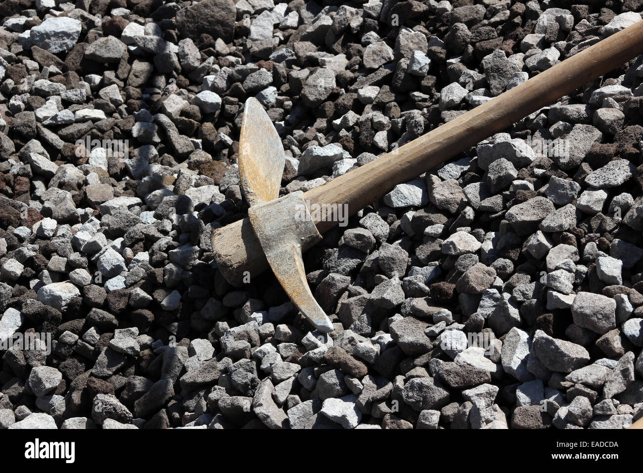 A pick axe lying on a pile of rocks at a construction site in Cotacachi, Ecuador Stock Photo