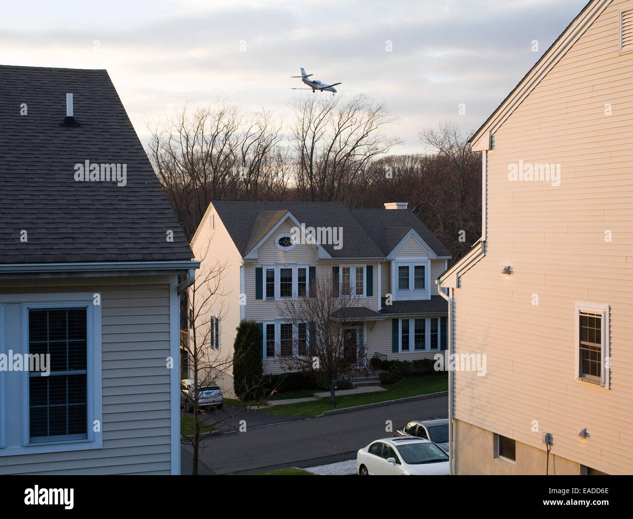 suburban development with airplane flying overhead Stock Photo