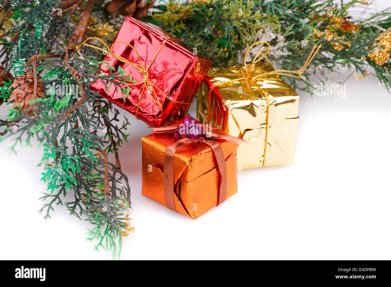 Christmas boxes and fir tree branches on white background Stock Photo ...