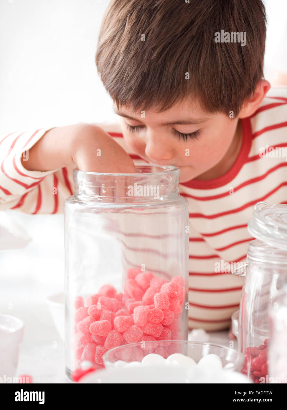 boy getting candy from jar Stock Photo Alamy
