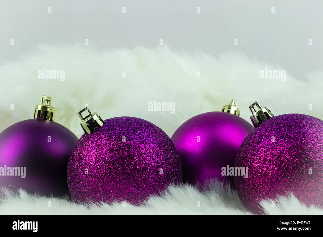 Purple christmas decorations on white fur Stock Photo
