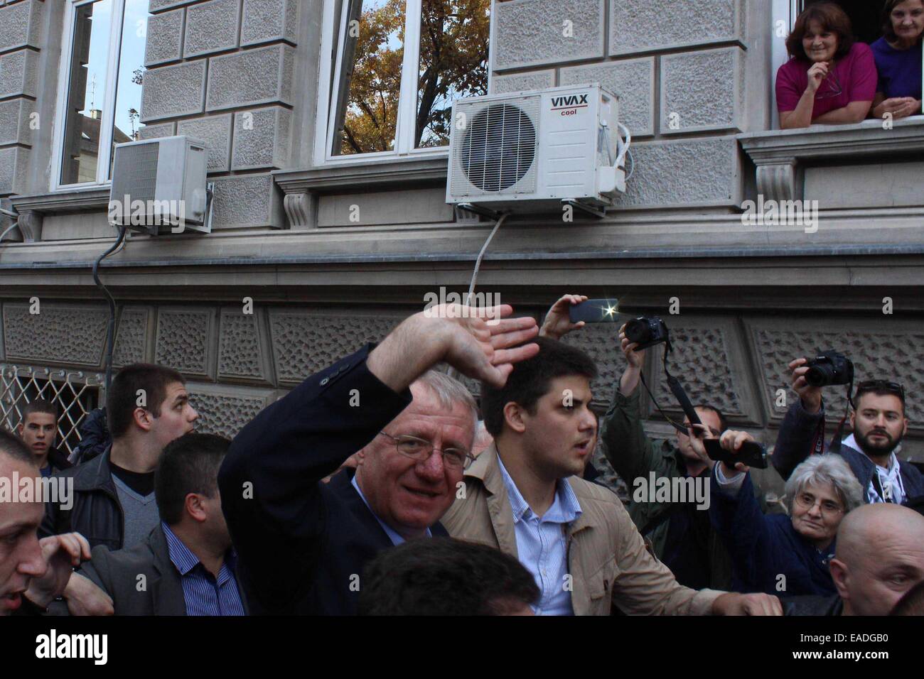 Belgrade. 12th Nov, 2014. Vojislav Seselj (C), former leader of the Serbian Radical Party, arrives at his party headquarters in Belgrade, Serbia, on Nov. 12. Vojislav Seselj who was indicted for war crimes was provisionally released due to health reasons on Wednesday. Credit:  Nemanja Cabric/Xinhua/Alamy Live News Stock Photo