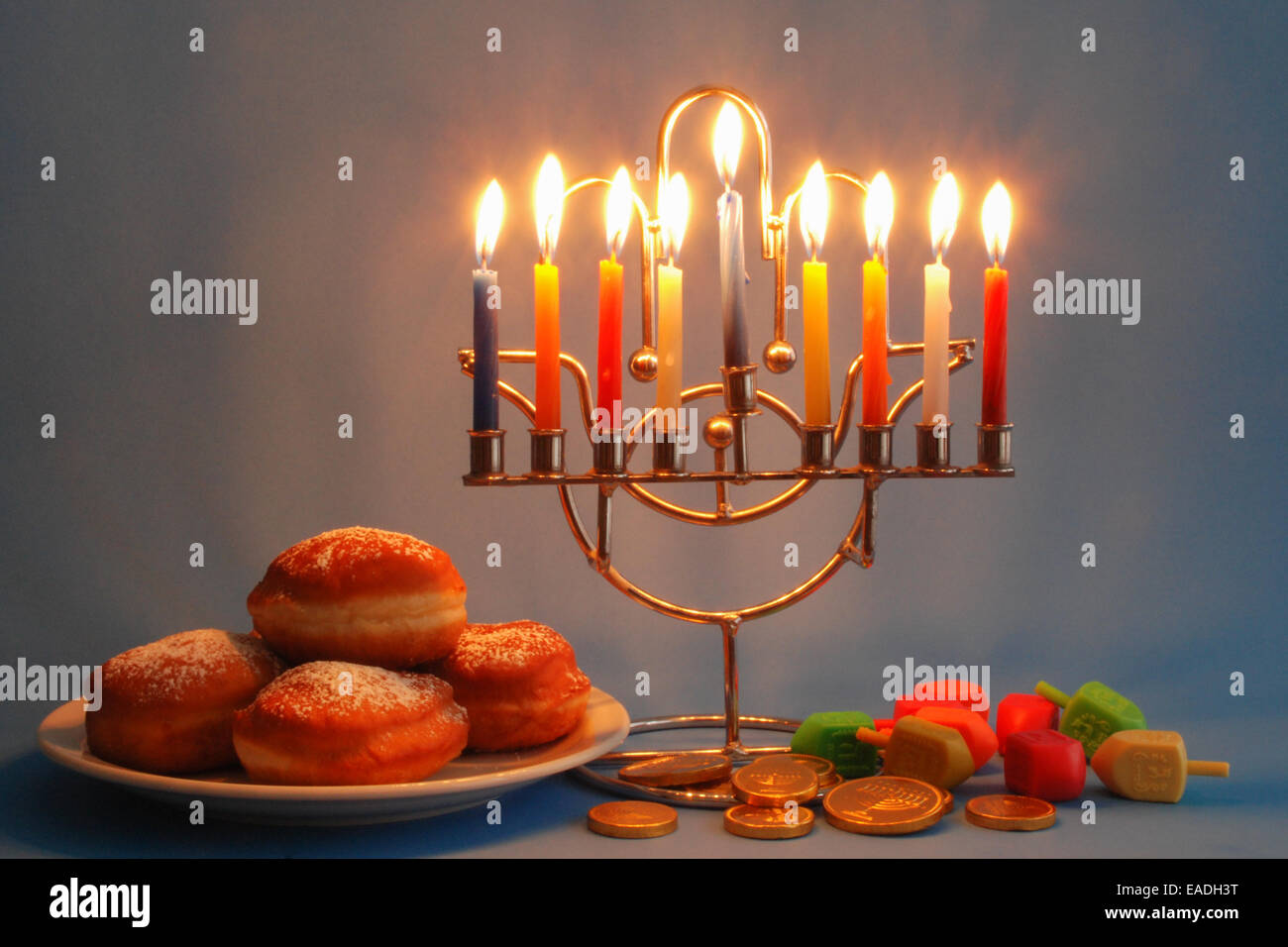 Symbols of Hanukkah holyday, Menorah with candles, donuts, dreidels and