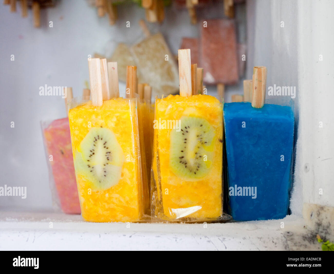 Brightly colored popsicles in freezer Stock Photo