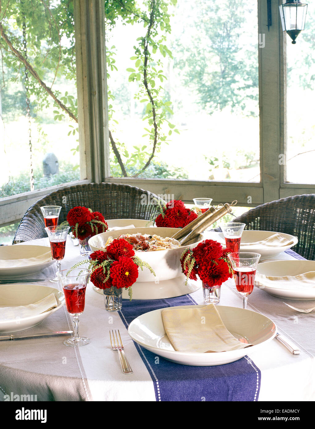 Summer meal on set table in screened in porch Stock Photo