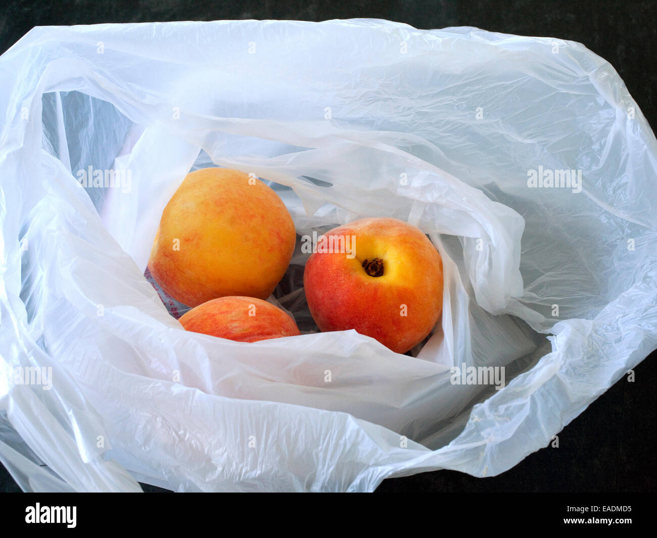 Peaches in bag on counter Stock Photo Alamy