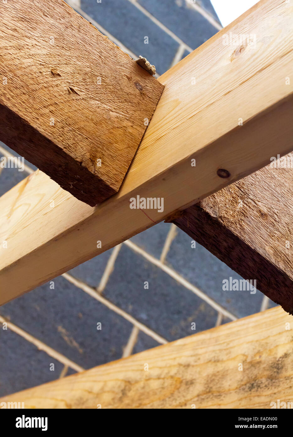 Detail of wooden roof beams on a building site where a new house is being constructed using timber and breeze blocks Stock Photo
