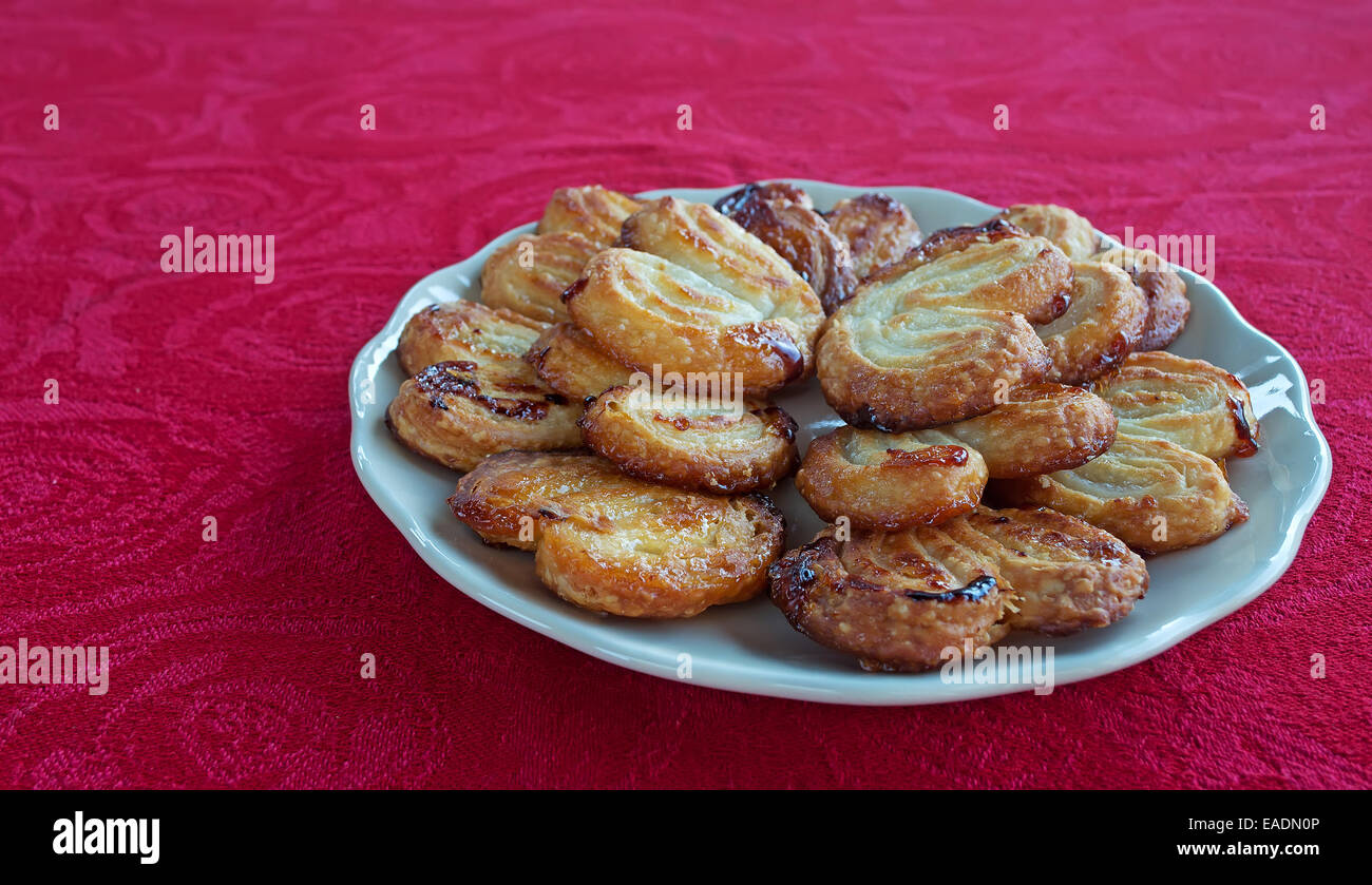 plate of fan-shaped pastries on a red table Stock Photo - Alamy