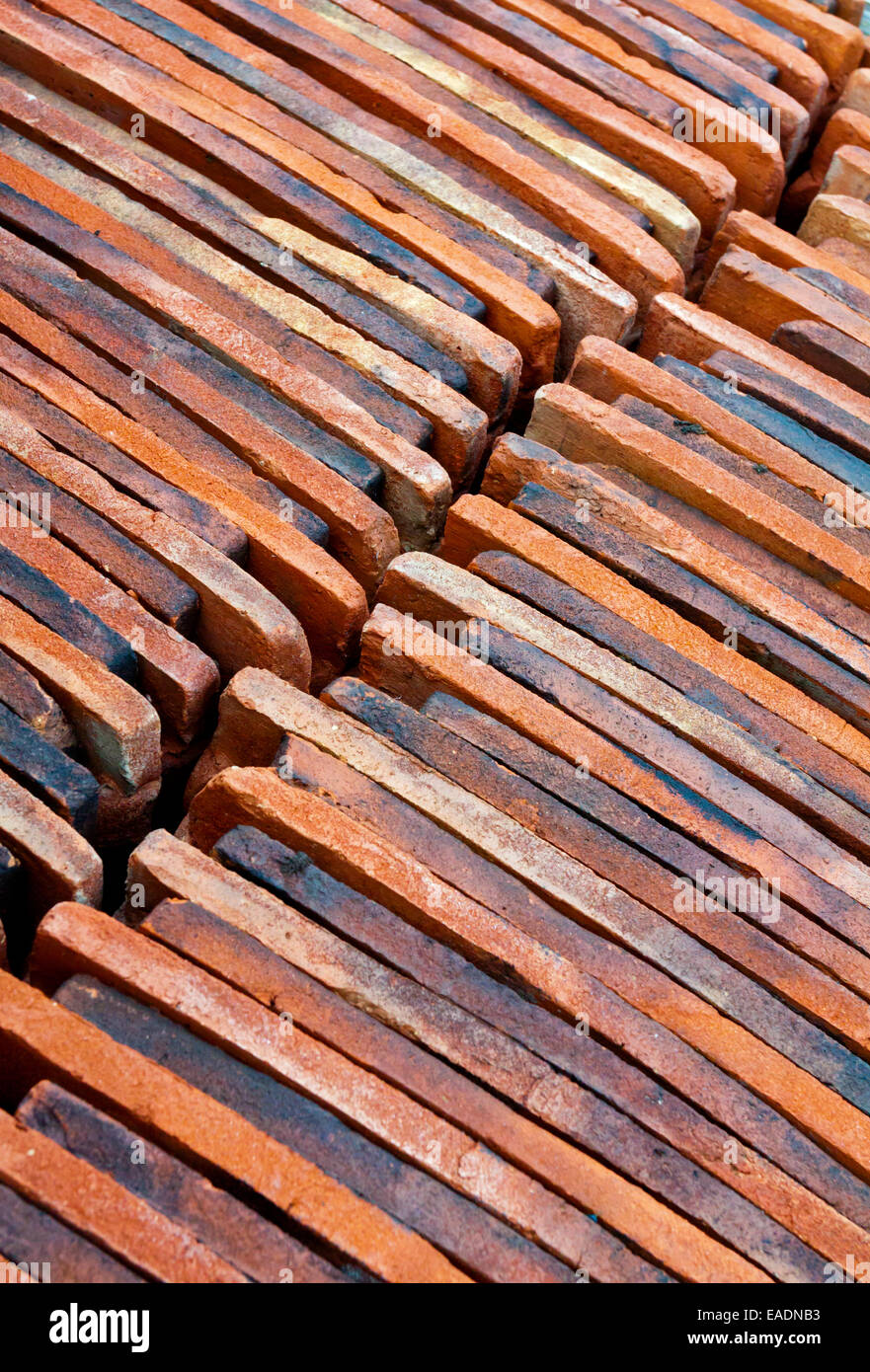 Detail of traditional red roofing tiles laid out ready to be used on a building site Stock Photo