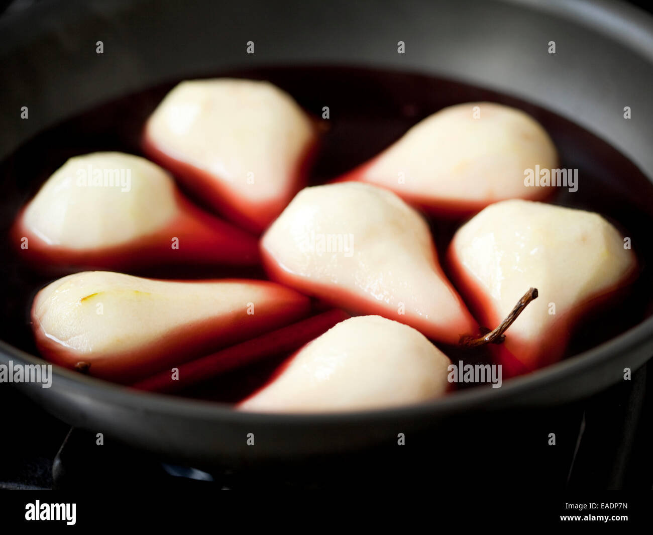 poaching pears in wine sauce Stock Photo