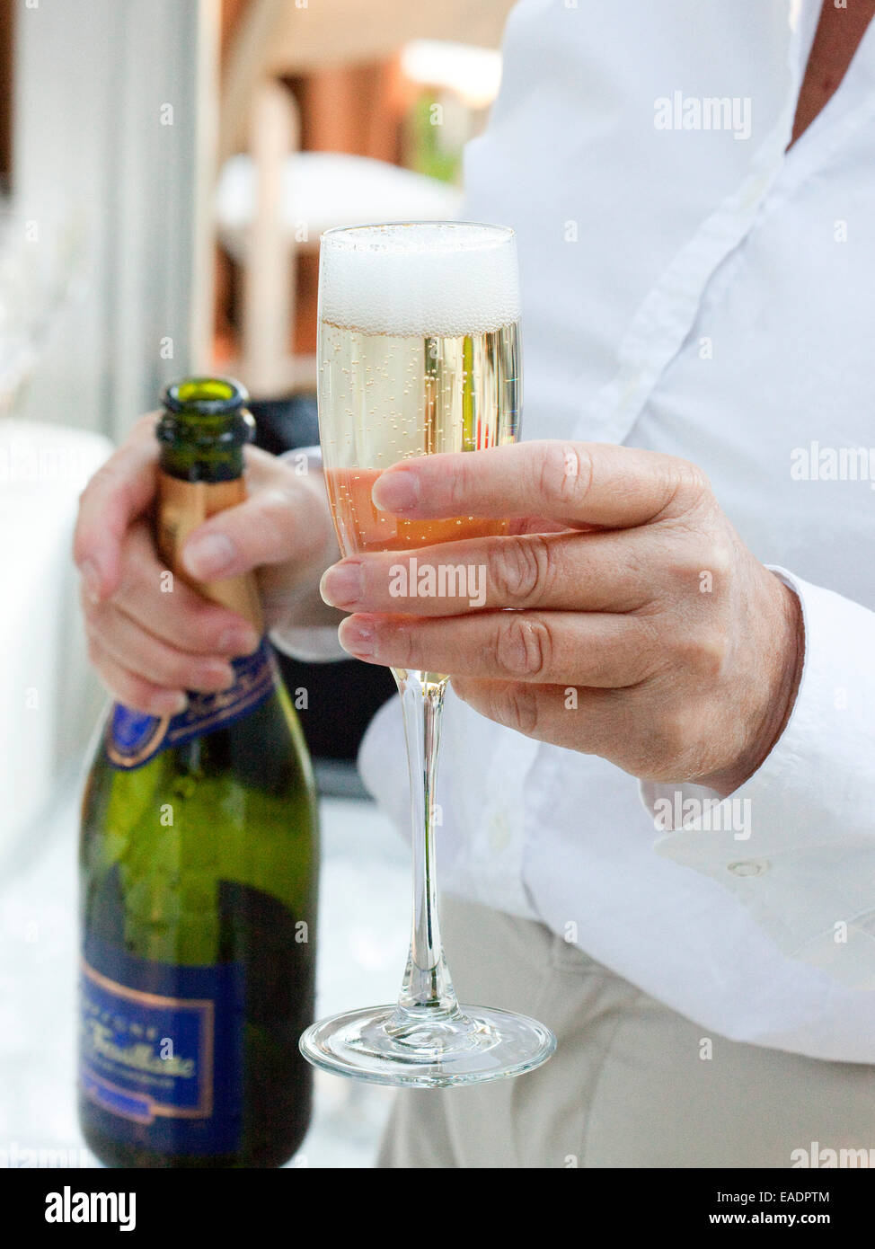 serving a glass of champagne Stock Photo