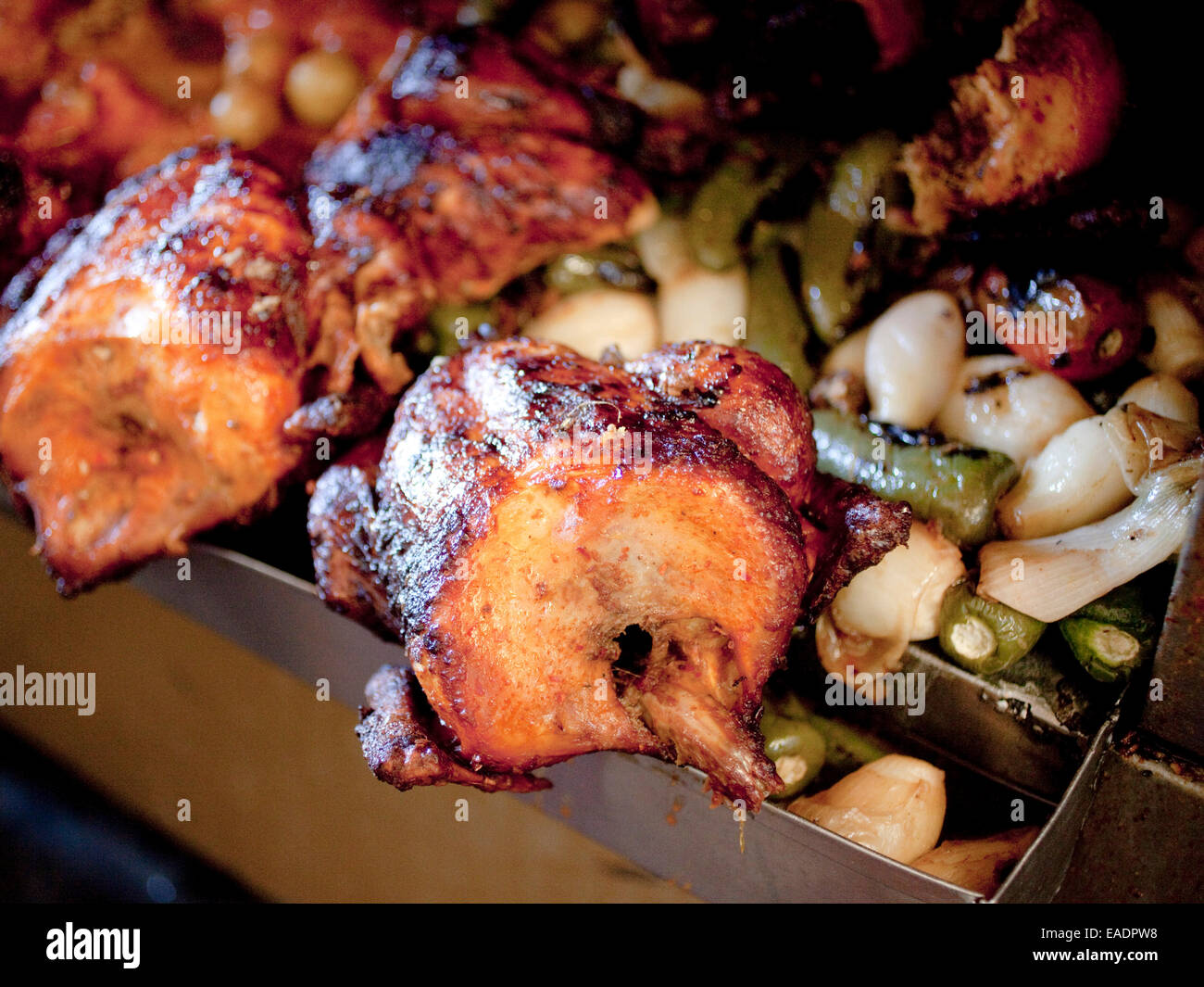 Chicken roasting on spigot with various vegetables Stock Photo Alamy
