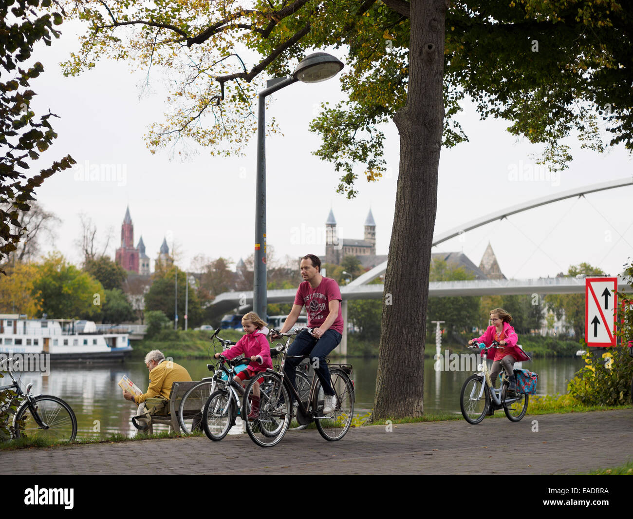 Man riding a bike with his daughters at the Charles Eyck Park in Maastricht, The Netherlands, Europe Stock Photo
