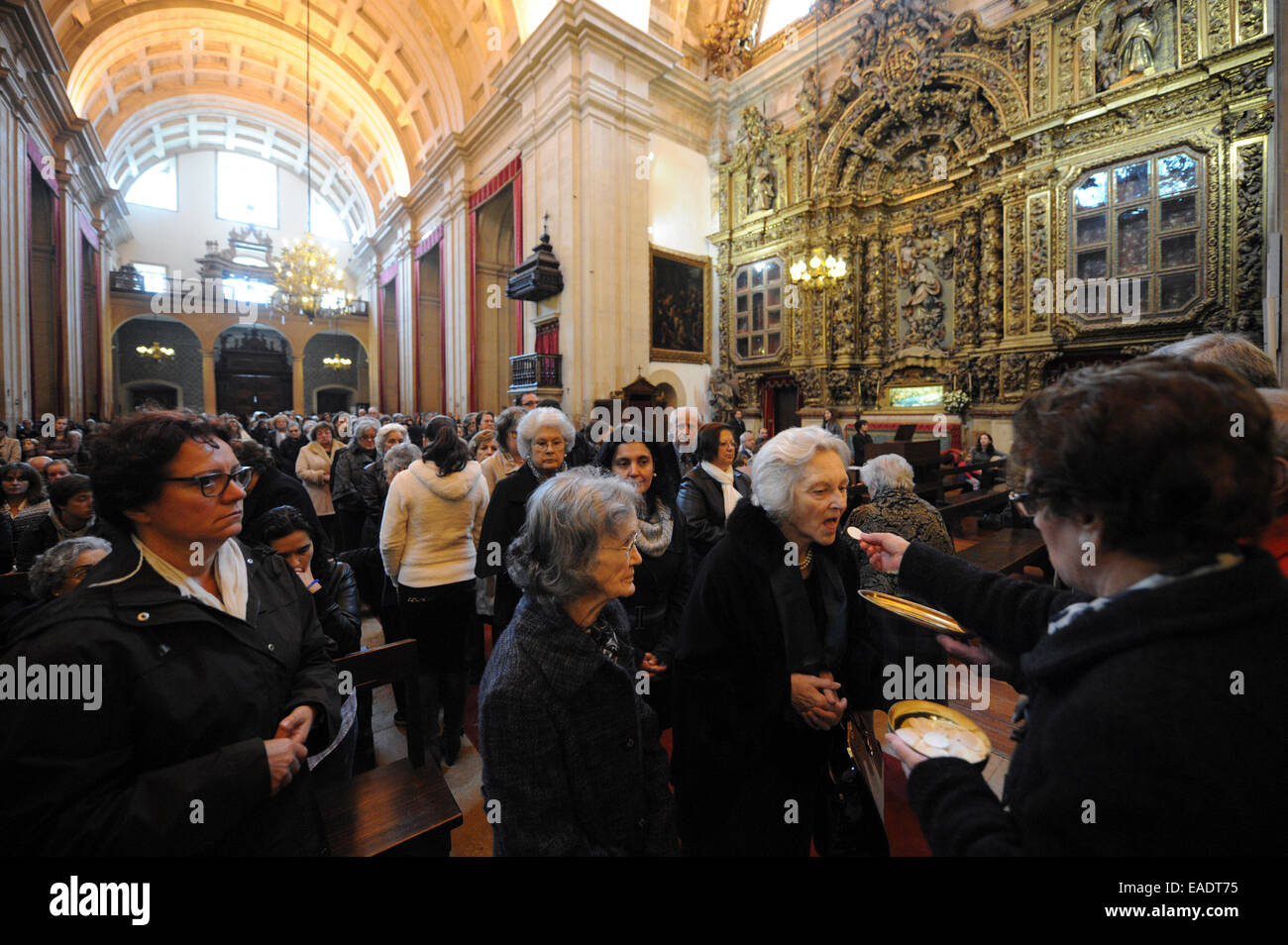 Communion during Catholic mass at the Sé Nova cathedral in Coimbra, Portugal, Europe Stock Photo