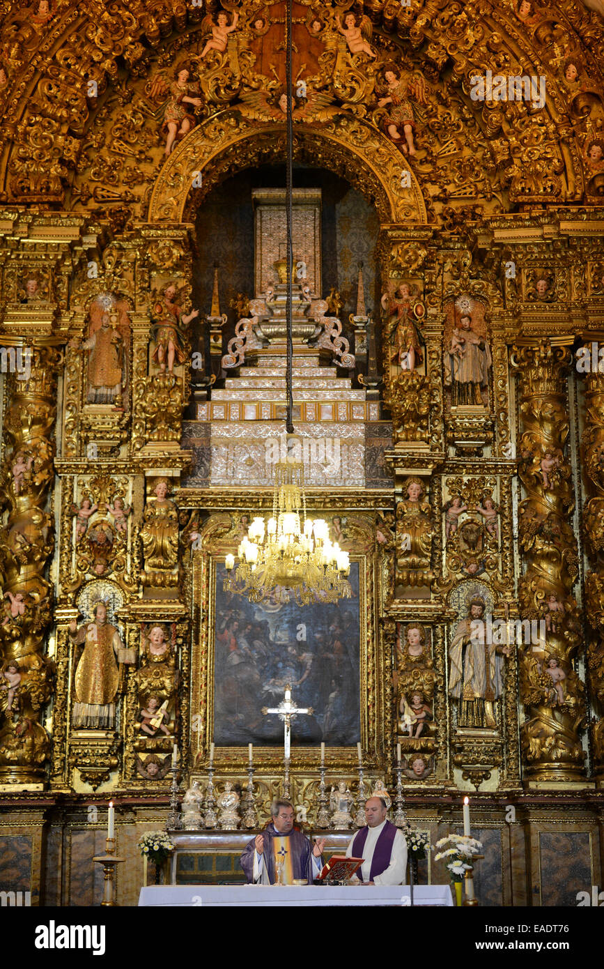 Priest celebrating catholic mass in front of the church altar Stock Photo