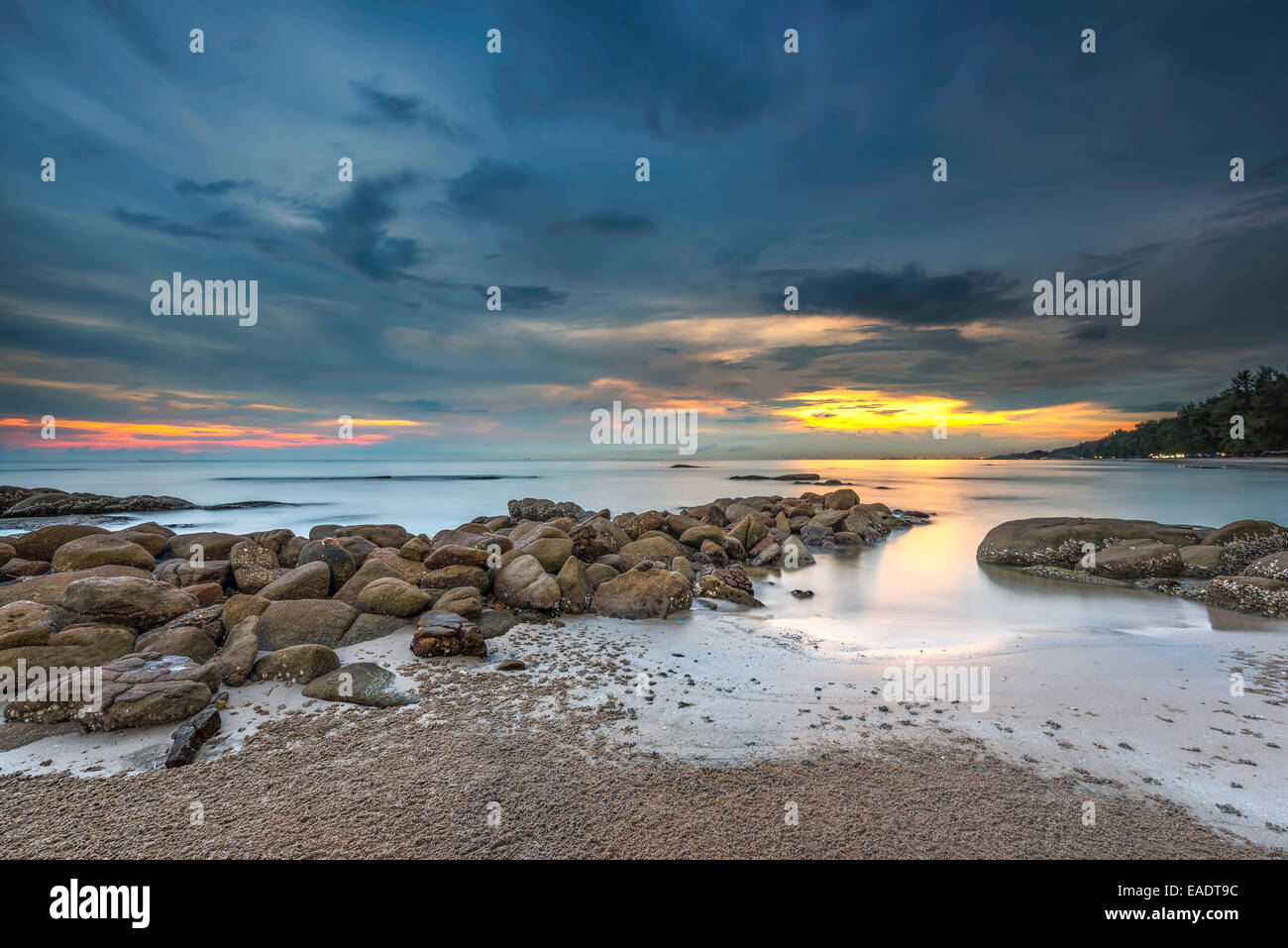 Sea with a sunset and the cloudy sky Stock Photo - Alamy