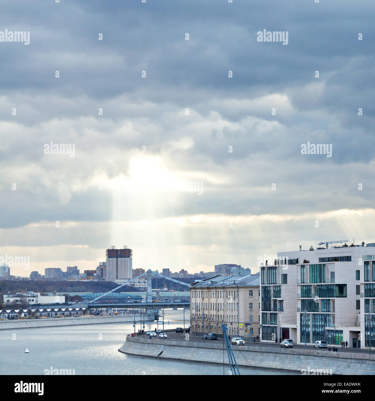 Moskva River, Prechistenskaya embankment, and sunbeams illuminating Moscow building of the Russian Academy of Sciences in cloudy Stock Photo