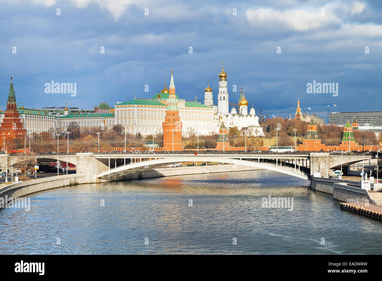 sunlight illuminated Bolshoy Kamenny bridge, Moskva River and Moscow Kremlin in autumn day Stock Photo