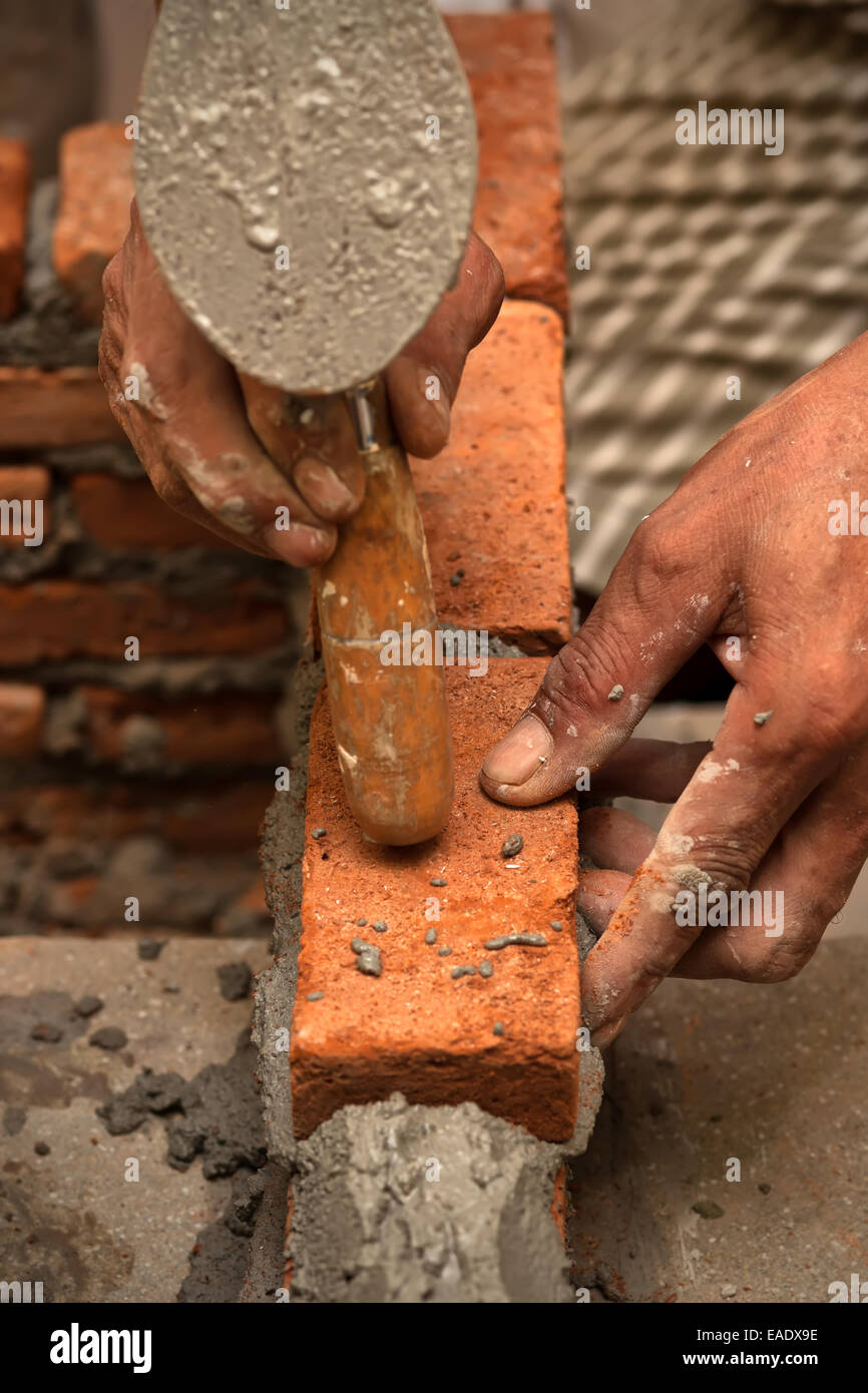 Worker laying brick wall with cement Stock Photo Alamy