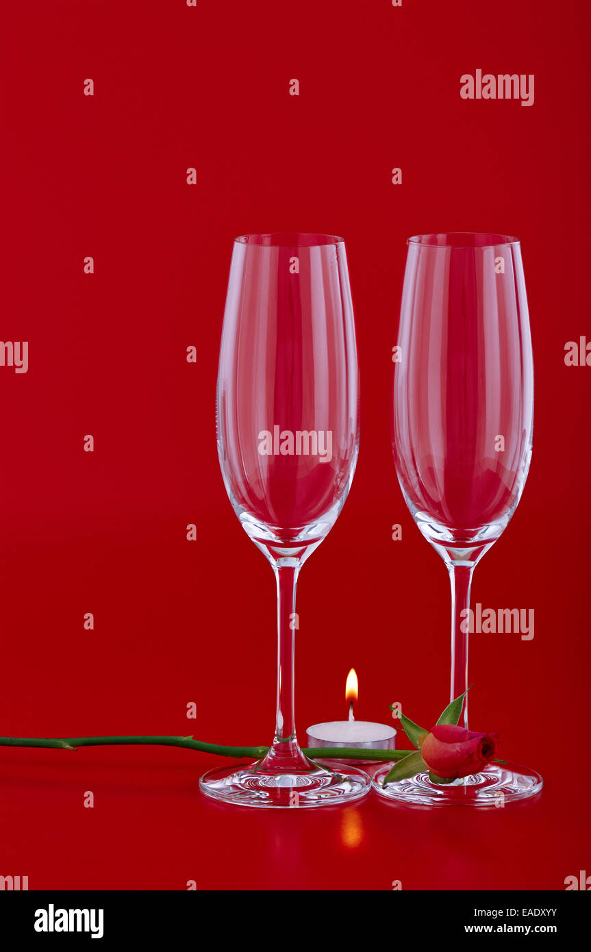 Two wine glasses with rose and candle over red background Stock Photo ...
