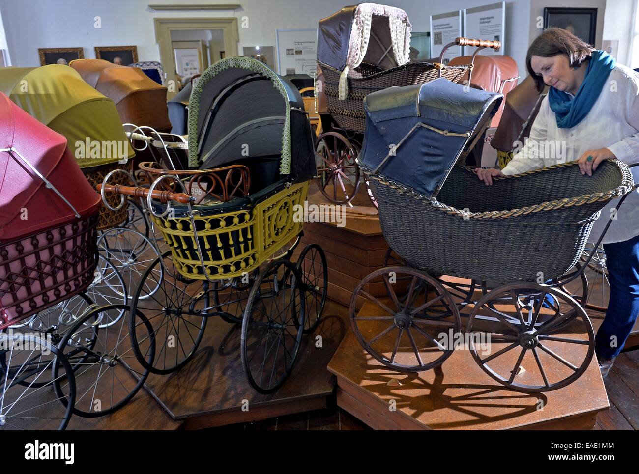 Zeitz, Germany. 12th Nov, 2014. ARCHIVE - the director of the 'Deutsche  Kinderwagen Museum' (lit. 'German baby carriage museum'), Kristin Otto  stands next to a group of Zeitz' baby carriages from 1900
